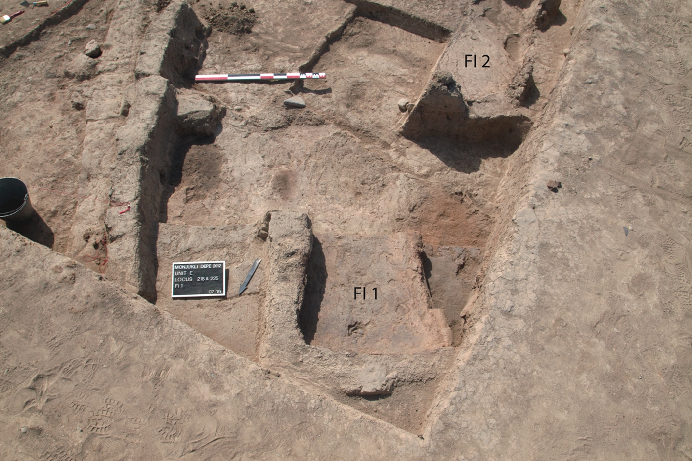 Two ovens, FI 1 and 2, located to the north of House 2. FI 1 is a double-chambered oven, one chamber of which lay partly outside the excavation area. FI 2 consisted of a single-chambered oven.