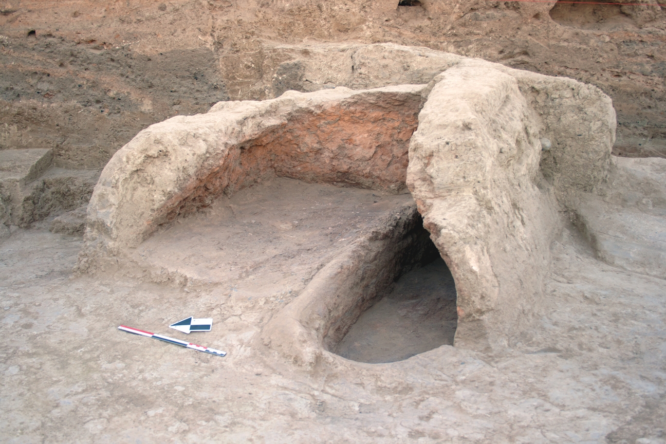 A double-chambered oven, FI 44, in House 10. It was located immediately next to the entrance to the house, partially visible to the right of the oven at the edge of the photo.