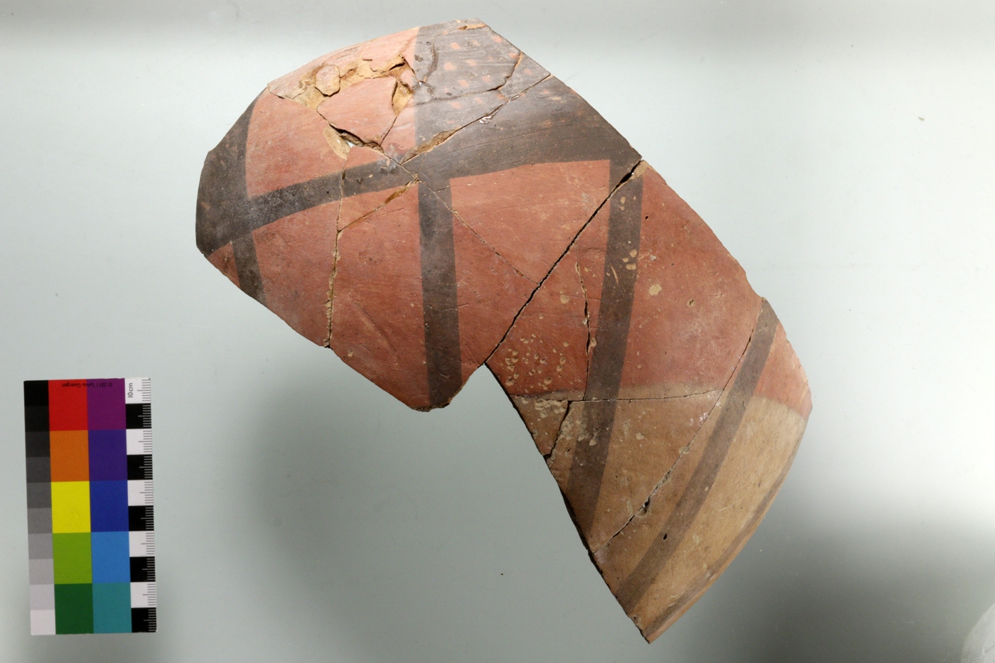 Large Meana Black on Red incurved rim bowl with crosshatched rectangles along the rim and lines towards the base. The lighter reddish color at the lower part is probably the result of firing the vessels that were stacked in one another.