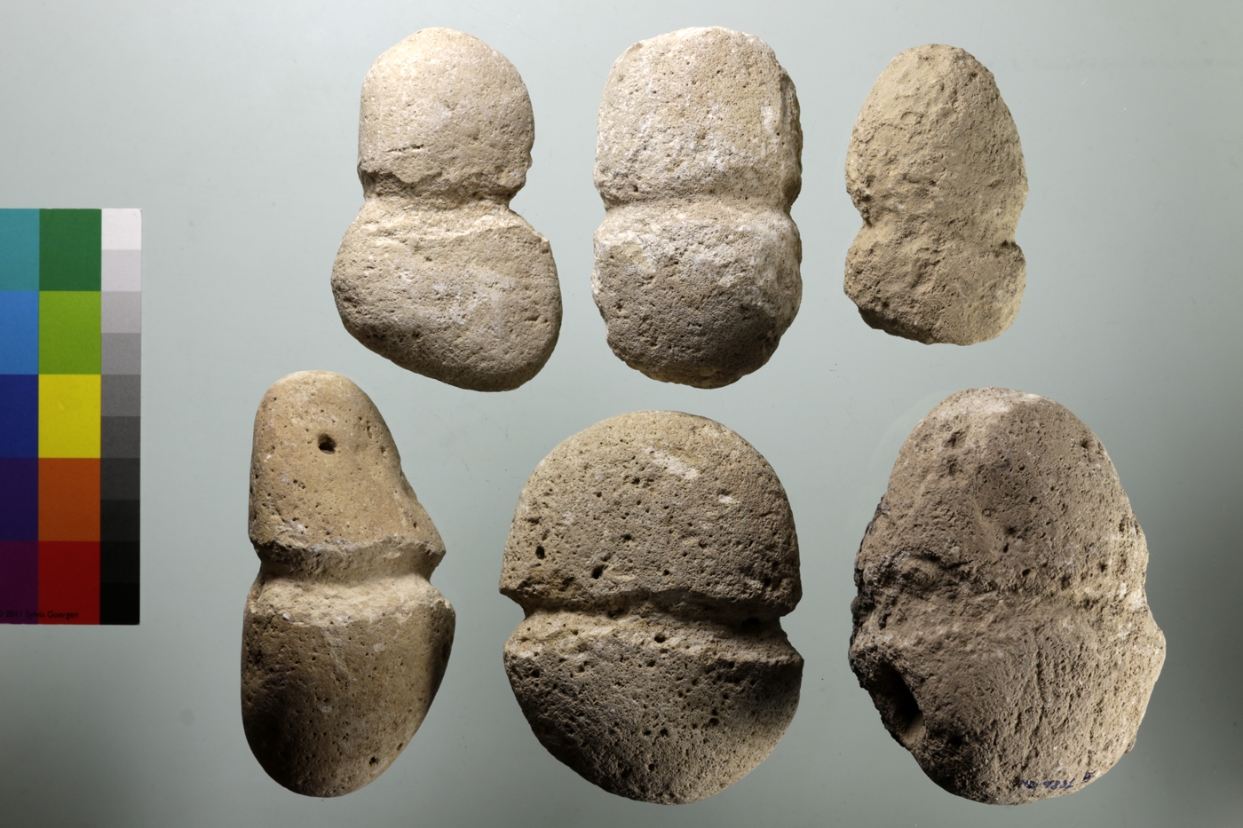 Stones with a narrow groove around their circumference, probably to permit them to be hung and used as weights.