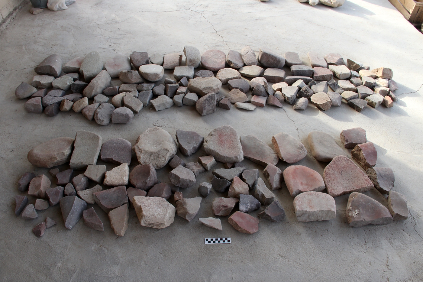 Grinding stones in various shapes, degrees of use, and fragmentation