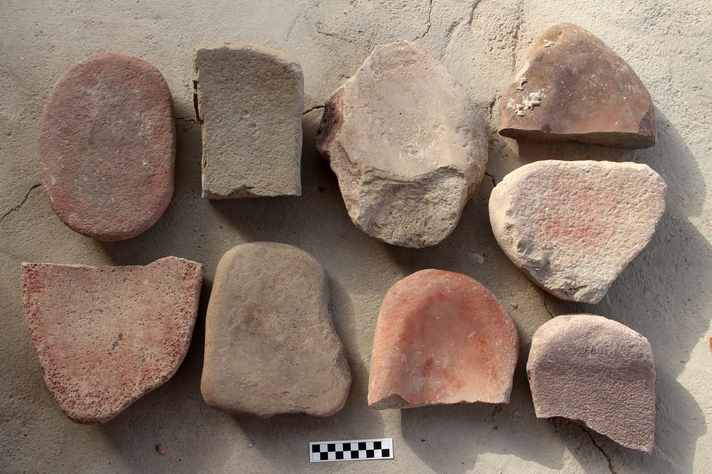 Grinding stones, several of which show traces of ocher