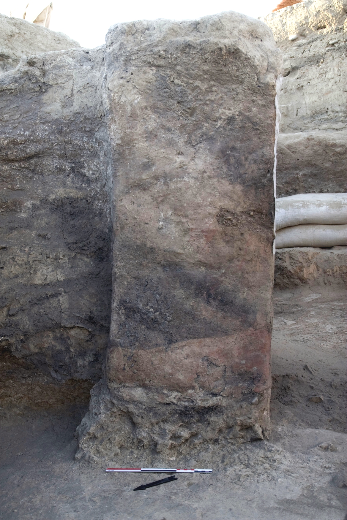 A view of the backside of the painted buttress in House 14. The dark ashy stripes are remains of the burnt fill in the house. A portion of the painting can be seen just above the lower ashy stripe.