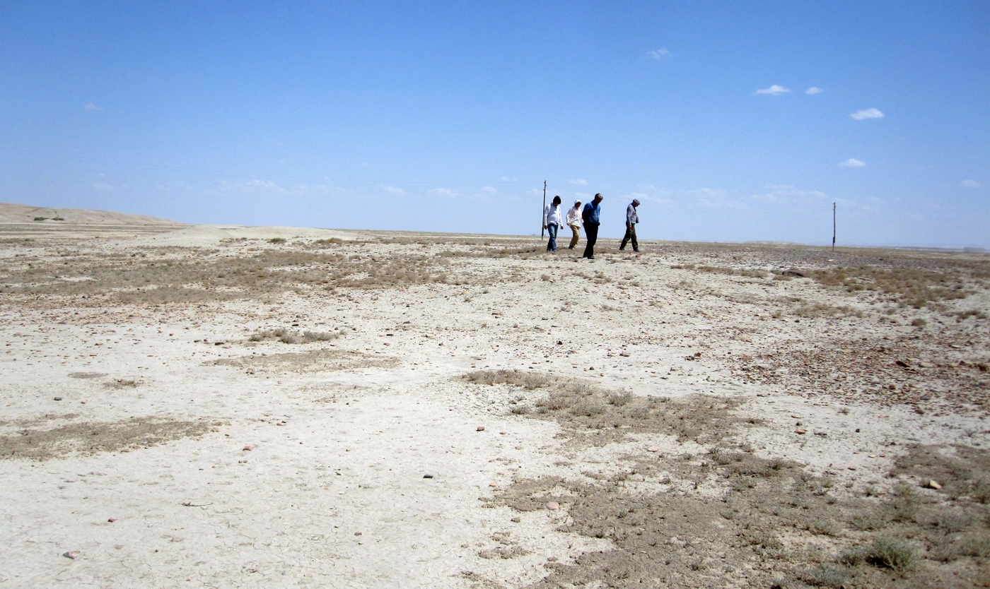 Checking out a site in the Chaacha-Meana survey area. On the left side of the photo is the edge of the large Bronze Age site of Altyn Depe.